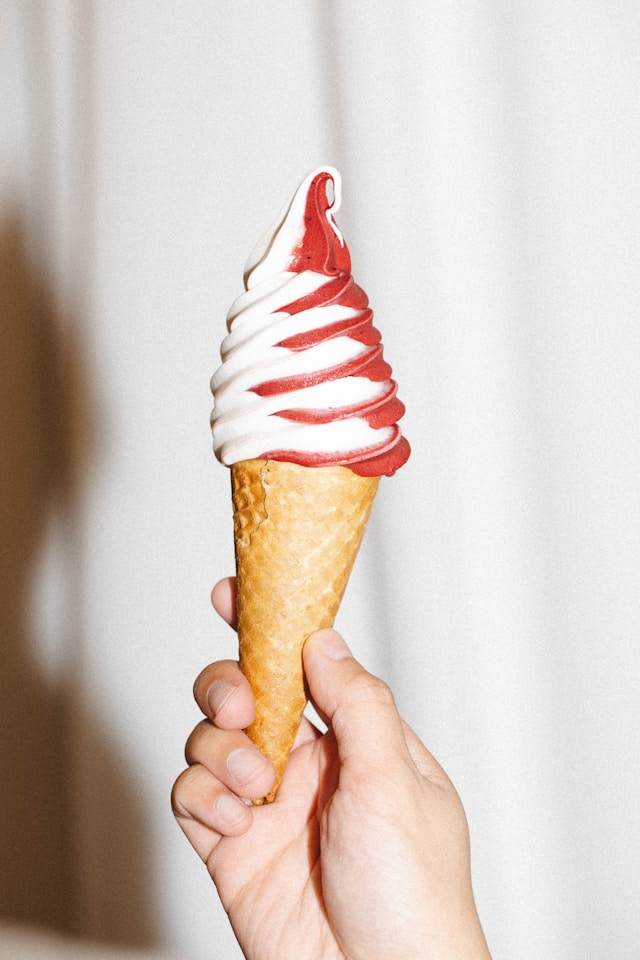 person holding soft serve in cone