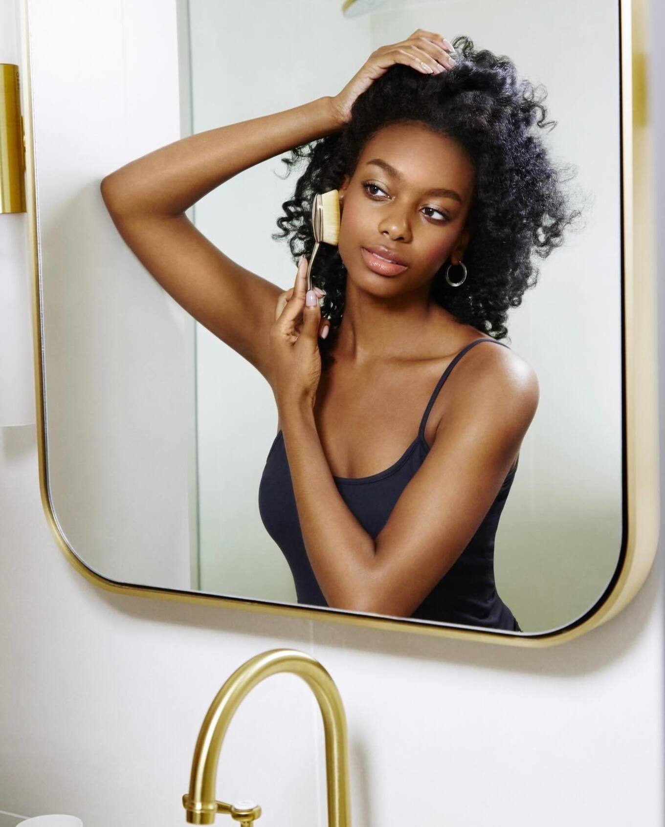 woman using Artis makeup brush